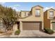 Two story house with brown garage door and landscaping at 9156 Mcginnis Ave, Las Vegas, NV 89148