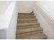 Beige carpeted stairs leading to the second floor at 9704 Villa Lorena Ave, Las Vegas, NV 89147