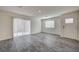 Bright living room featuring gray floors and sliding glass doors at 10079 Dazzling Sunrays Ave # 0, Las Vegas, NV 89129