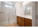 Modern bathroom with wood cabinets and walk-in shower at 1722 Game Garden Rd, North Las Vegas, NV 89031