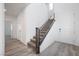 Modern staircase with dark wood railings leading to the second floor at 1722 Game Garden Rd, North Las Vegas, NV 89031