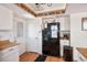 Kitchen with black refrigerator, white cabinets and wood countertops at 3609 Woodglen Ct, Las Vegas, NV 89108