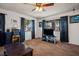 Living room with ceiling fan, dark brown carpet, and a TV stand at 3609 Woodglen Ct, Las Vegas, NV 89108