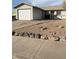 Ranch style home with a single car garage and a rock border at 427 E Barrett St, Henderson, NV 89011