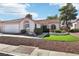 Single-story house with a two-car garage, landscaped yard, and neutral color scheme at 6065 Shadow Oak Dr, North Las Vegas, NV 89031