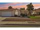 Single-story house with a two-car garage, landscaped yard, and neutral color scheme at 6065 Shadow Oak Dr, North Las Vegas, NV 89031