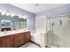 Elegant bathroom with double sinks, soaking tub, and walk-in shower at 7552 Chambery Cove Ct, Las Vegas, NV 89123