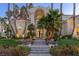 Elegant home entry with a modern black door and stone steps at 8109 Moonstone Cir, Las Vegas, NV 89128