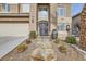 Elegant entryway with stone steps and ornate double doors at 8508 Vivid Violet Ave, Las Vegas, NV 89143