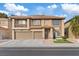 Two-story house with brown exterior, two-car garage, and landscaping at 8600 W Gilmore Ave, Las Vegas, NV 89129