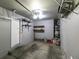 Garage with concrete floor, shelving, and water heater at 9927 Keephills St, Las Vegas, NV 89183