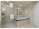 Bathroom with soaking tub, shower, and glass enclosure at 135 E Harmon Ave # 407, Las Vegas, NV 89109