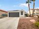 Single-story house with a two-car garage and desert landscaping at 1420 Daybreak Dr, Las Vegas, NV 89108