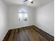 Bright bedroom featuring wood-look floors and an arched window at 1658 Garden Path Ct, Las Vegas, NV 89119