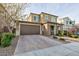 Two-story house with brown garage door and brick accents at 2179 Tortona St, Henderson, NV 89044