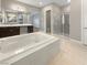 Bathroom features a large soaking tub and walk-in shower at 3408 Isle Dr, Las Vegas, NV 89141