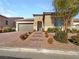 Single-story home with a two-car garage and landscaped front yard at 3408 Isle Dr, Las Vegas, NV 89141