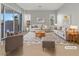 Virtually staged living room featuring beige sofas and a coffee table at 3408 Isle Dr, Las Vegas, NV 89141