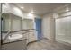 Bathroom with granite vanity, double sinks, and shower at 3764 Andorian Ave, North Las Vegas, NV 89084