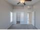 Carpeted bedroom with ceiling fan and walk-in closet at 4002 Redfield Ave, North Las Vegas, NV 89032