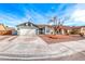 Single-story house with gray exterior, two-car garage, and landscaped front yard at 5308 Dana Springs Way, Las Vegas, NV 89130