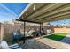 Backyard patio with covered seating area, grill, and artificial turf at 709 Jonathan Glen Way, Las Vegas, NV 89145