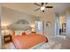 Spacious Primary bedroom with orange bedding and ceiling fan at 9209 Palmer House Ave, Las Vegas, NV 89149