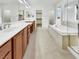 Elegant bathroom with double sinks, soaking tub, and walk-in shower at 11388 Newton Commons Dr # 104, Las Vegas, NV 89135