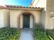 Inviting front door entry with arched detail and landscaping at 11388 Newton Commons Dr # 104, Las Vegas, NV 89135