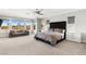 Large main bedroom with a plush bed, sitting area and mountain views at 11664 Morning Grove Dr, Las Vegas, NV 89135