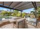 Outdoor kitchen with built-in grill and bar, perfect for entertaining at 11664 Morning Grove Dr, Las Vegas, NV 89135