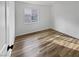 Simple bedroom with wood flooring and large window at 1559 Wild Willey Way, Henderson, NV 89002