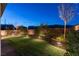 Spacious backyard with lawn area, patio, and landscape lighting at 16 Cresta Villa Ct, Henderson, NV 89011