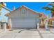 Cute one-story house with a two-car garage and landscaped front yard at 1950 Turtlerock St, Las Vegas, NV 89142