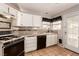 Clean kitchen featuring white cabinets, tile floors, and gas range at 1950 Turtlerock St, Las Vegas, NV 89142