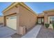 Tan stucco home with a two-car garage and walkway at 2535 Sierra Sage St, Las Vegas, NV 89134