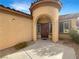 Inviting exterior with arched entryway and neutral color palette at 2653 Rue Montpellier Ave, Henderson, NV 89044