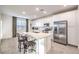 Modern kitchen with white cabinets, stainless steel appliances, and island at 3304 Viola Hills Ave, Henderson, NV 89044