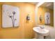 Simple, clean bathroom with pedestal sink and yellow walls at 5021 Apple Mesa Ave # Lot 222, Las Vegas, NV 89139