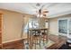 Bright dining area with wooden table and chairs, adjacent to kitchen and pool view at 5024 Glittering Star Ct, Las Vegas, NV 89130