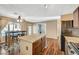 Open kitchen with granite island, stainless steel appliances, and wood cabinets at 5024 Glittering Star Ct, Las Vegas, NV 89130