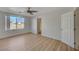 Bedroom with large window, ceiling fan, and wood floors at 632 Tonin Ave, North Las Vegas, NV 89031