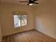 Bright bedroom with wood-look floors, ceiling fan, and window at 6821 Santa Isabel Ave # 104, Las Vegas, NV 89146