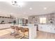 Modern kitchen with white cabinets, patterned backsplash, and island at 7392 Laredo St, Las Vegas, NV 89117