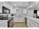 Modern kitchen with white cabinets, black appliances, and a breakfast bar at , Las Vegas, NV 89121