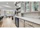 Elegant wet bar with glass-front cabinets and wine cooler at 5873 Skyfall Ct, Las Vegas, NV 89135