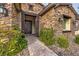 Inviting entryway with stone facade and a metal door at 8351 Agave Bloom St, Las Vegas, NV 89131