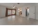 Open Gathering room with tile flooring, kitchen access, and sliding glass doors at 1325 Labrador Dr, Las Vegas, NV 89142