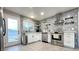 Modern kitchen with white cabinets, stainless steel appliances, and geometric tile backsplash at 2019 Beverly Way, Las Vegas, NV 89104