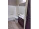 Clean bathroom with dark brown vanity, bathtub, and tiled floor at 2251 Wigwam Pkwy # 311, Henderson, NV 89074